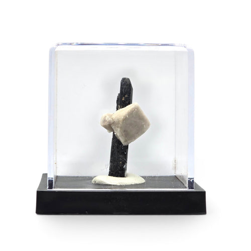 Aegirine and pale feldspar specimen shown inside its clear display case