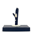 Front view of a tall black aegirine crystal with white feldspar crystals on a display base