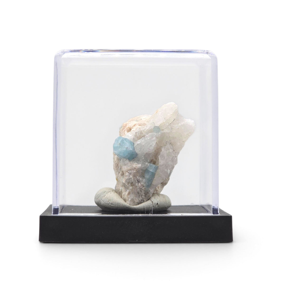 Aquamarine matrix specimen mounted upright beneath a clear display cover