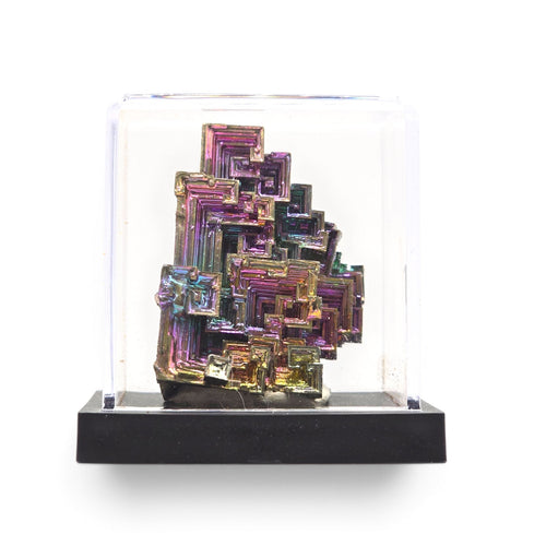 Front view of the colorful bismuth crystal cluster beneath a clear display cover