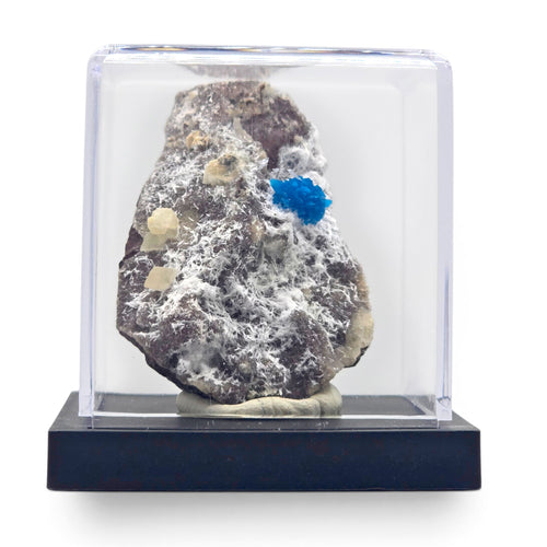 Cavansite and zeolite matrix specimen mounted inside a clear display case