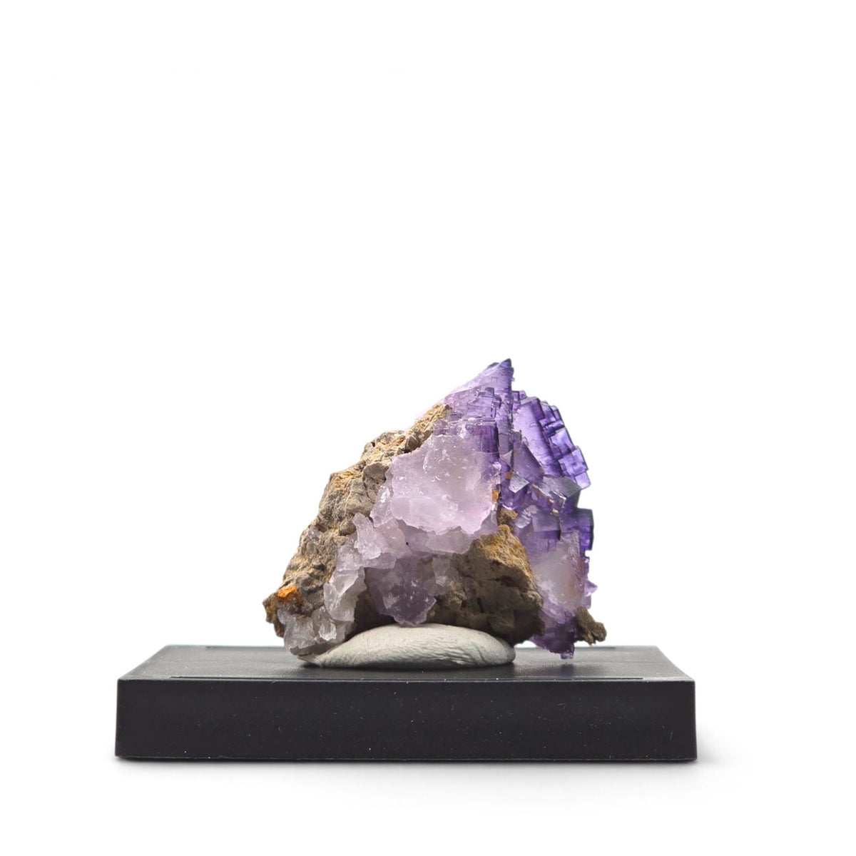 Rear angled view showing lavender fluorite, deeper purple stepped edges, and contrasting matrix