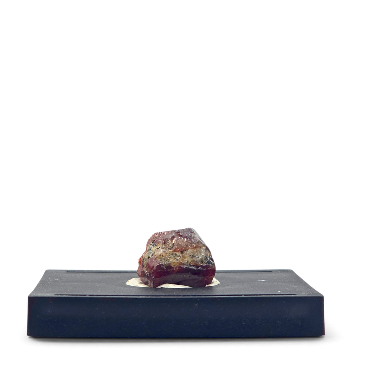 Rear view showing burgundy zircon surfaces and a band of tan host material